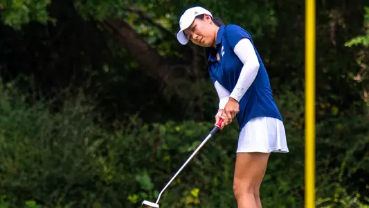 Elizabeth Jang completes her putt motion as she stares down her ball tracking to the hole.