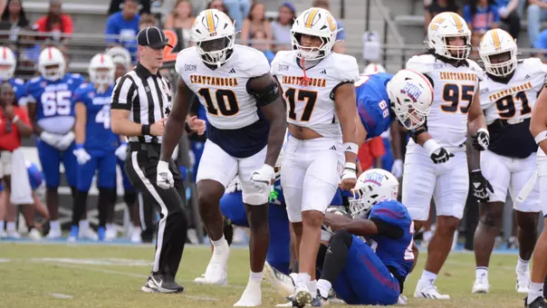 Orlando Daniels stands and celebrates with flexing arms a big tackle for loss at West Georgia