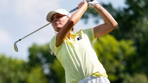 Claire Roberts poses in her finish as she stares down her tee shot