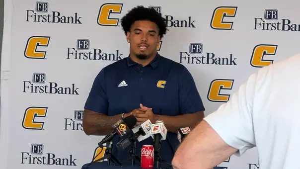 Nick Paul stands in front of the First Bank Power C media backdrop at this week's football press conference.