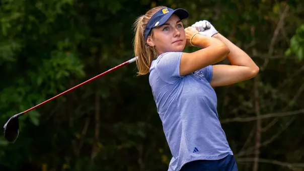 Claire Roberts watches her drive at the end of her swing with he driver angled behind her
