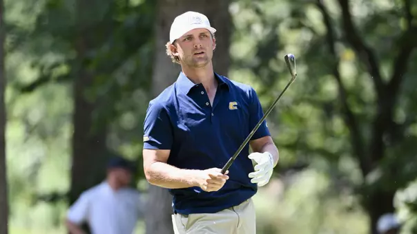 Ward Harris begins to approach his ball in his pre-shot routine with club still pointed ahead as he concentrates on what is to come.
