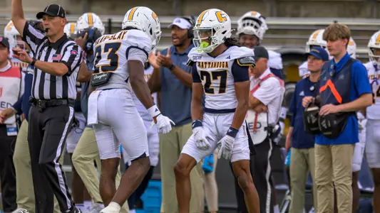 DJ Adams and Kam Baah-Slay (back to the camera) celebrate a big tackle from Adams in the win over West Georgia