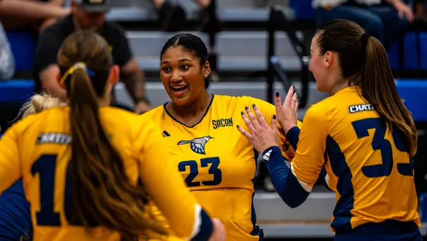 Gracie Rose high fives her teammates after UTC won a point