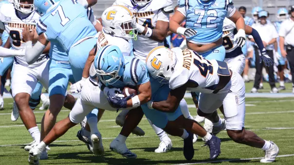 Zion Rutledge brings down a Citadel runner with Martez Cooksey, Jr., closing down.