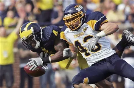 Mark Singer knocks the ball out of the grasp of Michigan's Brandon Minor.