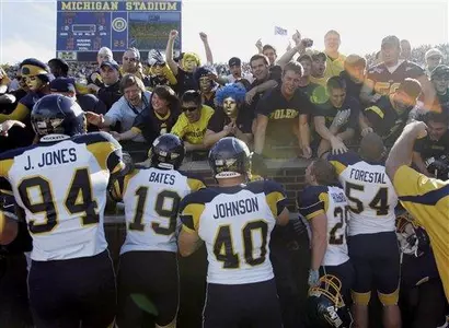 Toledo players celebrate with fans after Michigan win