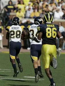 Toledo safety Tyrrell Herbert (28) races to the end zone vs. Michigan.