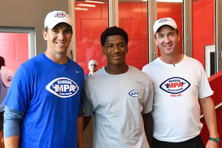 Dequan Finn with Manning brothers