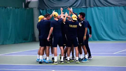 men's tennis team huddle