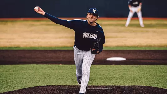 Nathan Leininger throws a pitch in a dark blue Toledo uniform