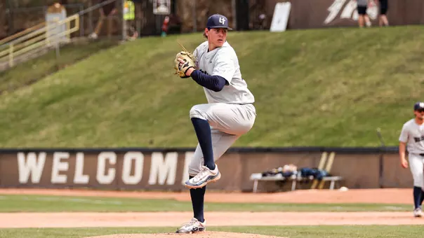 Michael Fliss throws a pitch in a gray uniform