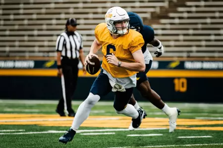 QB John Alan Richter evades a pass rusher at 2026 Spring Game