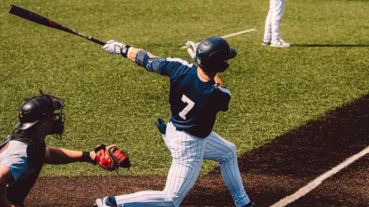 Cade Baker swings a bat