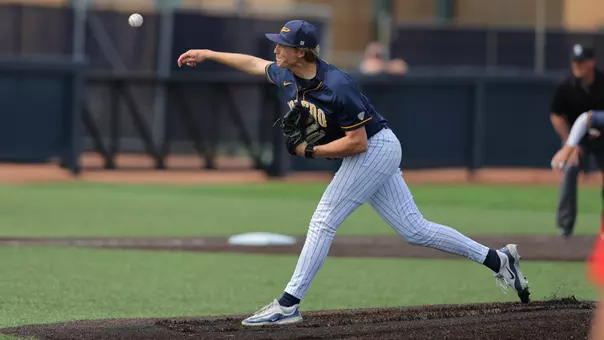 Nathan Leininger throws a pitch in a blue uniform
