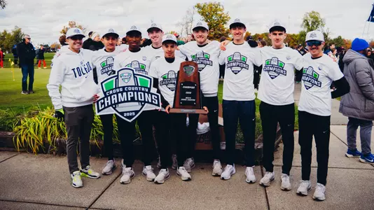 Toledo Men's Cross Country with the MAC Championship trophy following the championship meet.