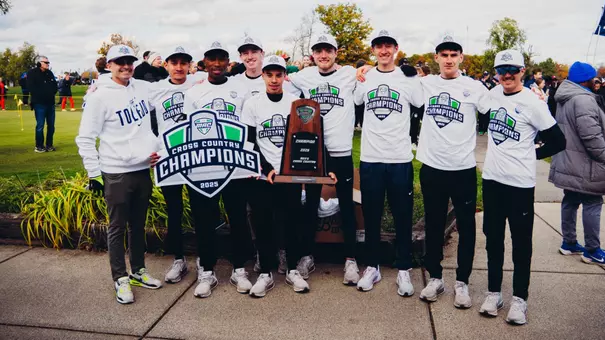 Toledo Men's Cross Country with the MAC Championship trophy following the championship meet.