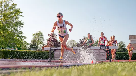 Hannah Ielfield runs into the water during the 3000m steeplechase at the 2026 MAC Outdoor Championships