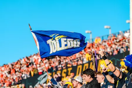 Fans cheer at the Glass Bowl and wave a Toledo flag