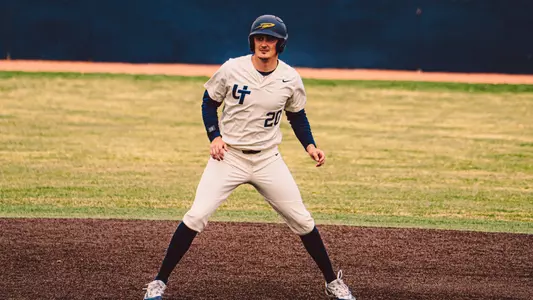 Cole Cahill taking a lead in a white uniform