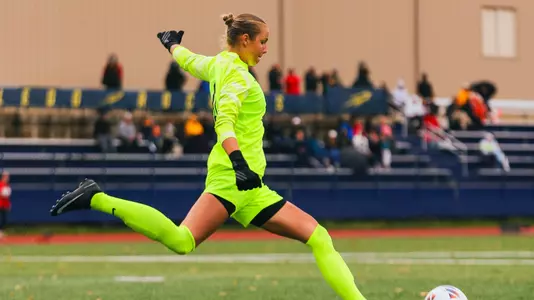 Agnes Stenlund goes to kick a soccer ball on a goal kick