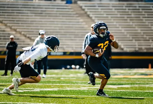 CJ Miller rushing the football