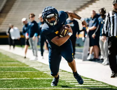 CJ Miller running down the sideline