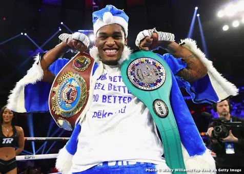 Jared Anderson flexing with championship belts
