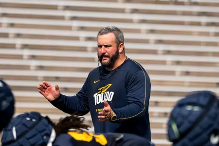 Toledo offensive line coach Brian Folkerts coaching during practice