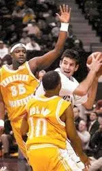 Thaydeus Holden (10) and Ron Slay (35) converge on Texas A&M's Brian Brookhart after a rebound.