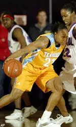 Loree Moore, who tallied 11 points, 10 rebounds and five assists, drives on DePaul's Charlene Smith during the first half.