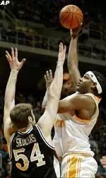 Tennessee's Brandon Crump shoots for two of his 20 points over Vanderbilt's Ted Skuchas during the first half.