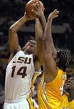 Tennessee's Brandon Crump, right, gets his hand on the ball to block the shot of Louisiana State's Jaime Lloreda (14) during the first half Wednesday Feb. 4, 2004, in Baton Rouge, La. No foul was called. (AP Photo/Bill Feig)