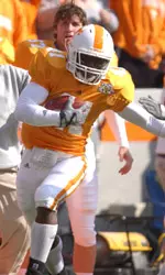 Rogan Carrying Football During Game