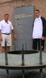Terezin Standing Next To Plaque