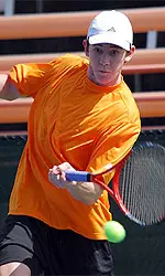 Hensel Swinging Racket At Tennis Ball