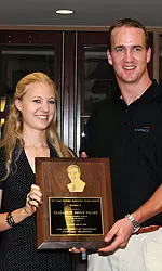 Peyton Manning Holding An Award With Someone