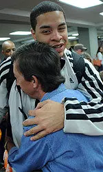 A Tennessee fan greets Brian Williams in McGhee Tyson Airport on Sunday night as the Vols returned from the NCAA Tournament in St. Louis.