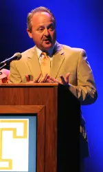 Person Speaking On A Stage At Podium
