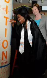 Bass signs the graduation pole