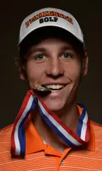 Goss taking a bite of his U.S. Amateur medal