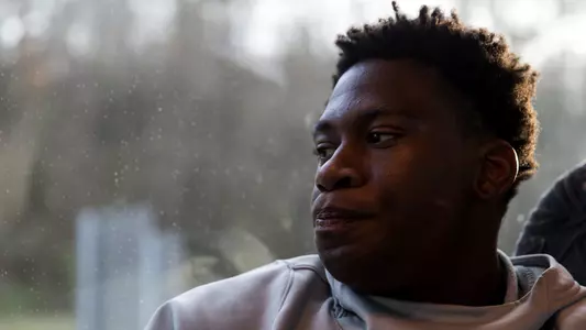 Admiral Schofield looks out a rainy window on a bus trip to ETSU