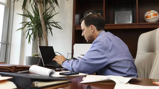 John Currie Working in His Office