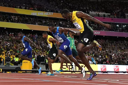 (L-R) First placed US athlete Justin Gatlin, second placed US athlete Christian Coleman and third placed Jamaica's Usain Bolt compete in the final of the men's 100m athletics event at the 2017 IAAF World Championships at the London Stadium in London on August 5, 2017. Photo Credit: AFP/Getty Images / KIRILL KUDRYAVTSEV