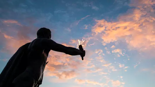 Torchbearer at sunset