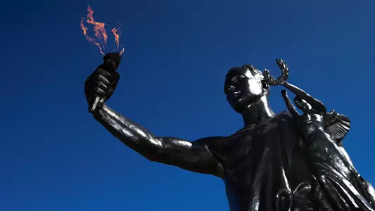 Torchbearer with clear blue sky