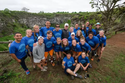 Group Posing For Photo Wearing Blue Galapagos Islands Shirt