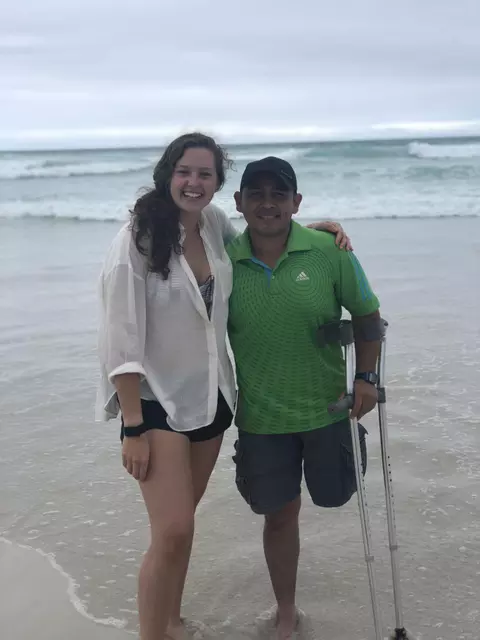 Two People Standing On Beach
