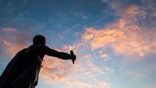 Torchbearer at sunset