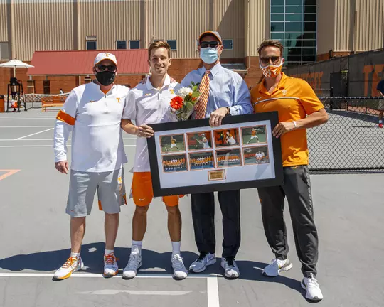 KNOXVILLE, TN - April 11, 2021 - Volunteer Assistant Coach Ian Van Cott, Luca Wiedenmann, Head Coach Chris Woodruff, and Associate Head Coach James McKie of the Tennessee Volunteers before the game between the Texas A&M Aggies and the Tennessee Volunteers at Goodfriend Tennis Center in Knoxville, TN. Photo By Caleb Jones/Tennessee Athletics